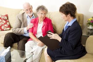 Geriatrician consulting an elderly couple.